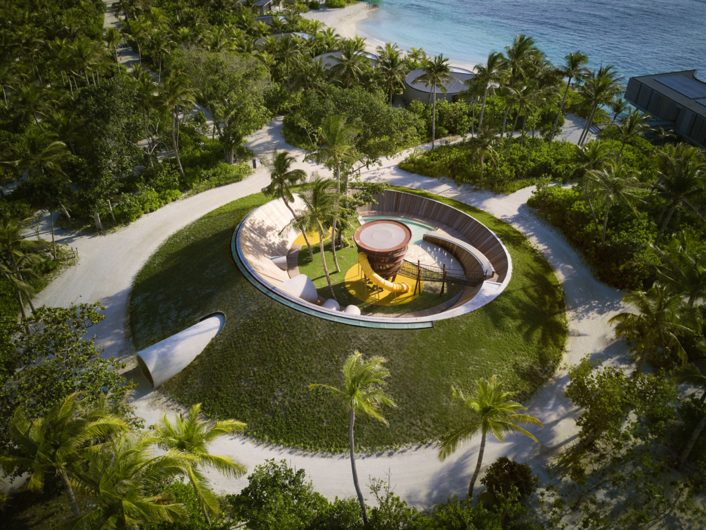 The Ritz-Carlton Maldives Fari Islands kids area, featuring an outdoor play area and circular structures